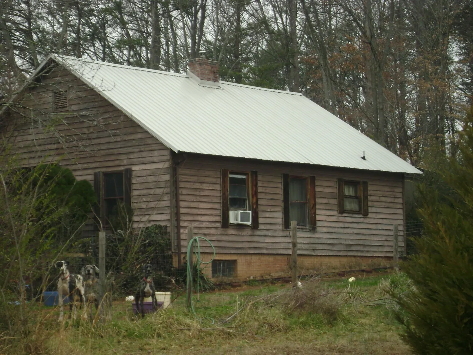 White metal roof on an old wood sided farmhouse, from a Metal Roof Installation job in Friedens
